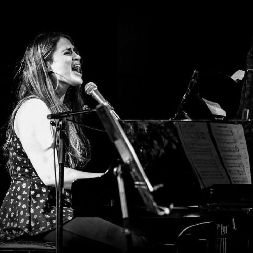 Liz Leila singing while playing piano